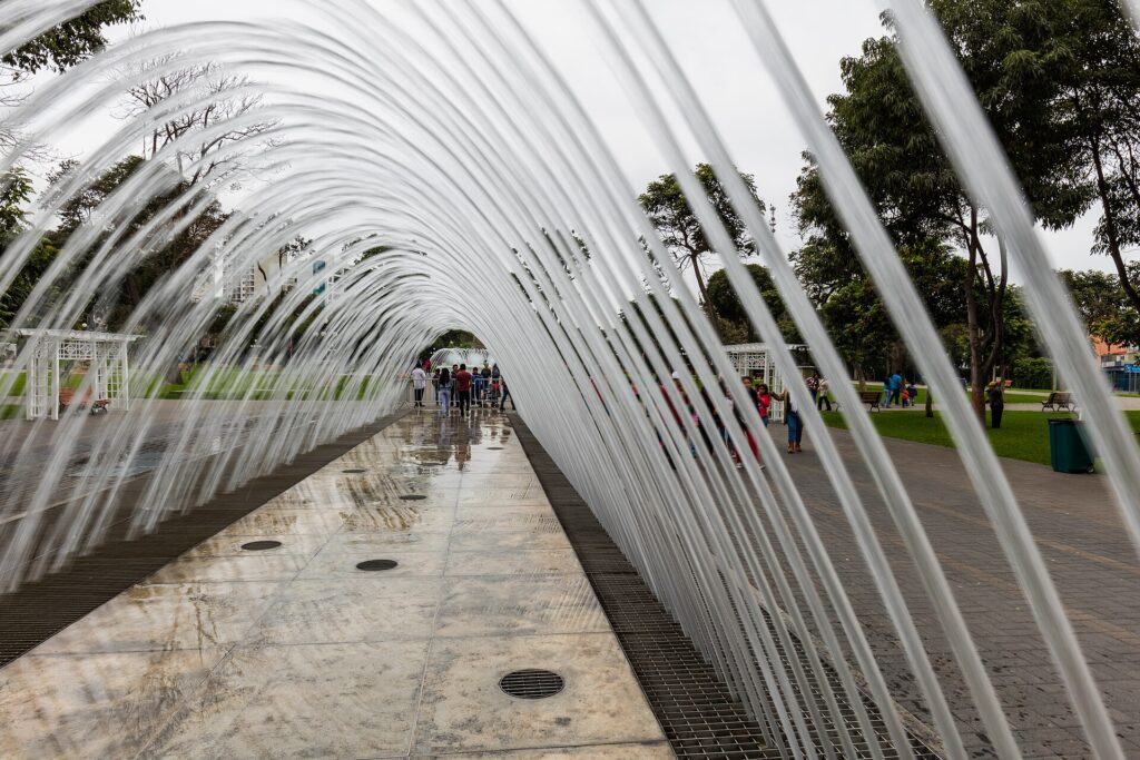 Arches of water forming a tunnel that visitors walk through at the Magic Water Circuit in Lima's Parque de la Reserva