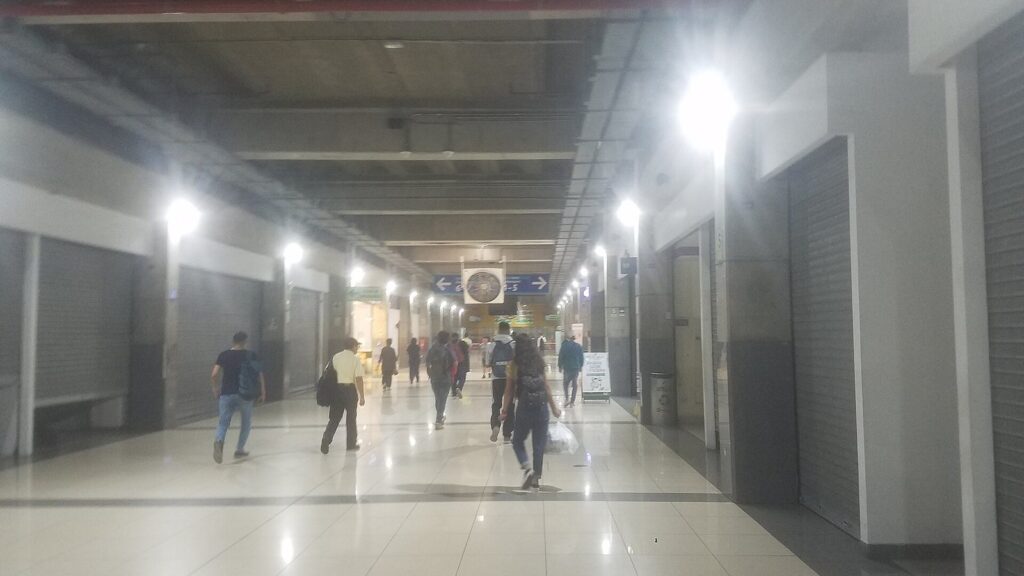Underground concourse of Estación Central on Lima's Metropolitano bus rapid transit line with passengers walking under bright lights