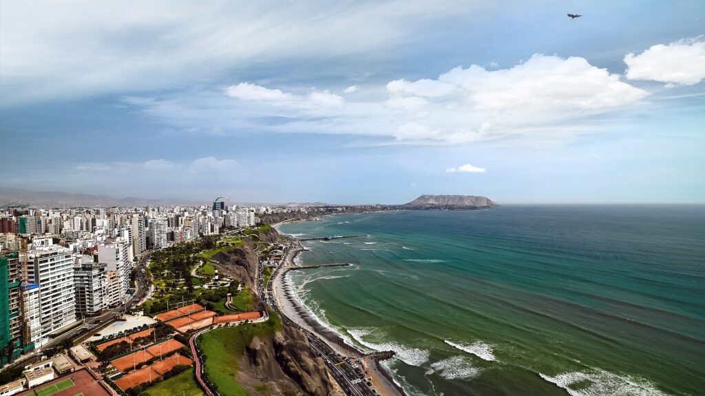 Aerial view of Miraflores in Lima, Peru, with clifftop parks and tennis courts above the Costa Verde highway, its beaches and the Pacific Ocean