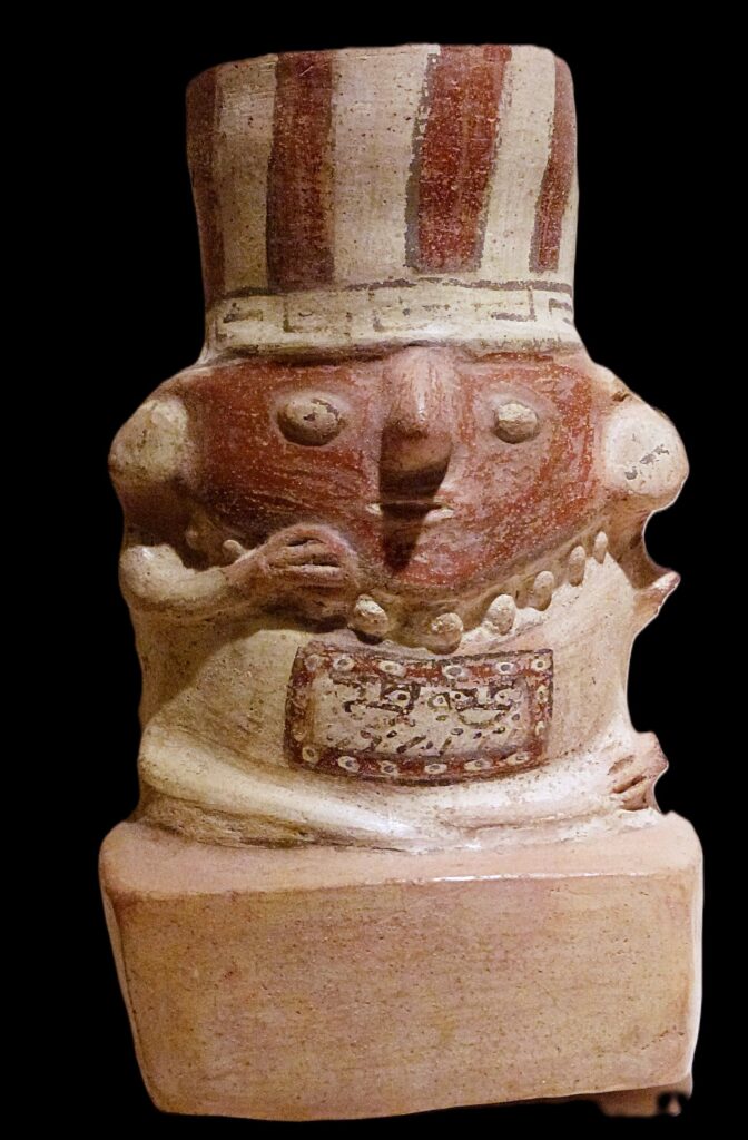 Painted Wari ceramic vessel shaped like a seated figure with a striped headdress, from the collection of Museo Larco in Lima