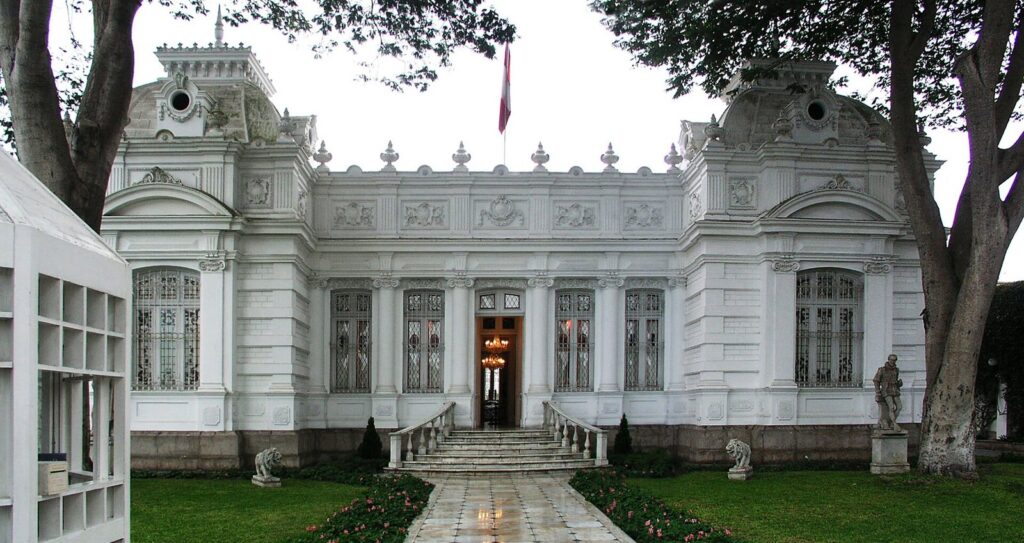 White Republican-era mansion of the Museo Pedro de Osma in Barranco, Lima, with a stone staircase, lawns and tall trees